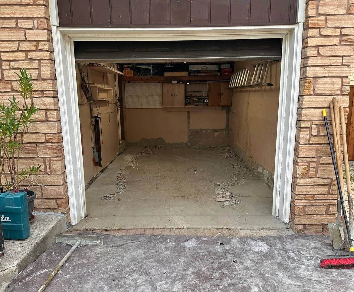 Cracked and pitted concrete garage floor before repair, Toronto